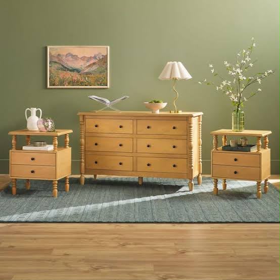A woman using a screwdriver while assembling furniture indoors